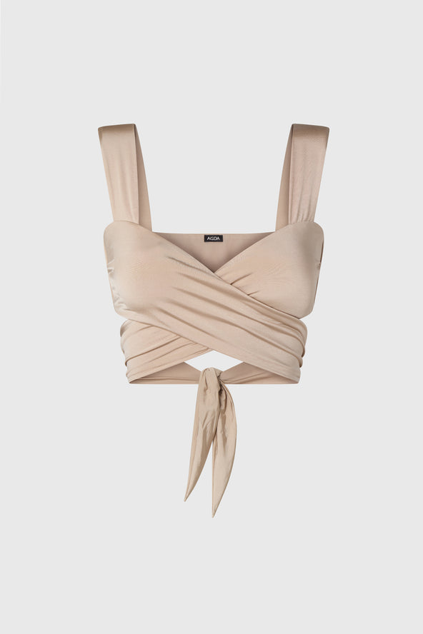 Wrap style bikini top in shimmering beige, on a white background